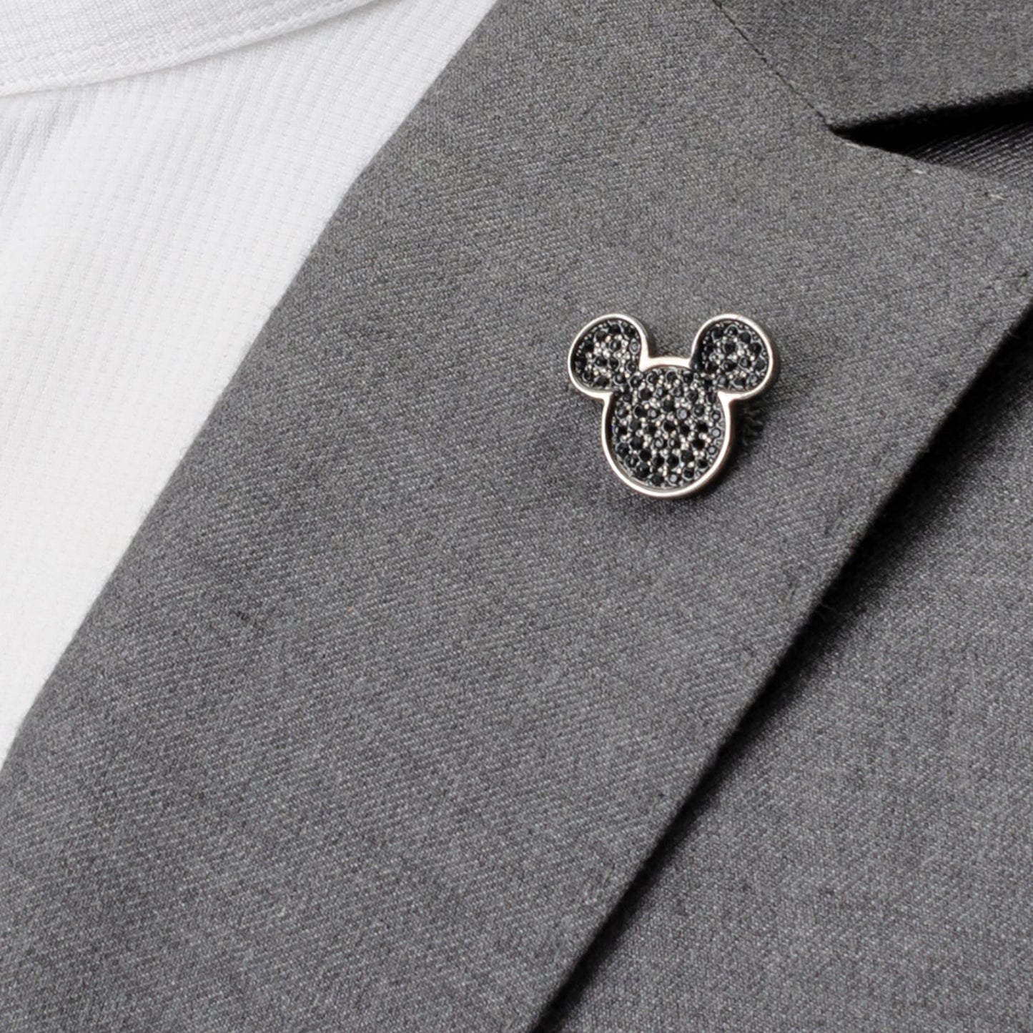The Disney Mickey Mouse Black Pave Crystal Lapel Pin by Cufflinks.com shines with pave crystals in a sleek black finish, styled as the iconic Disney silhouette, set against a white background.