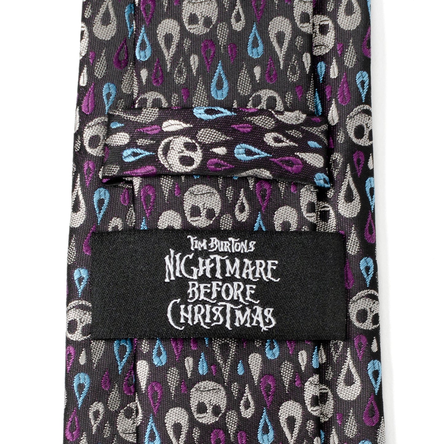 The Disney The Nightmare Before Christmas Jack Skellington Patterned Men's Tie by Cufflinks.com features a black silk blend with white skulls and blue and purple teardrops—perfect for fans seeking a unique accessory.