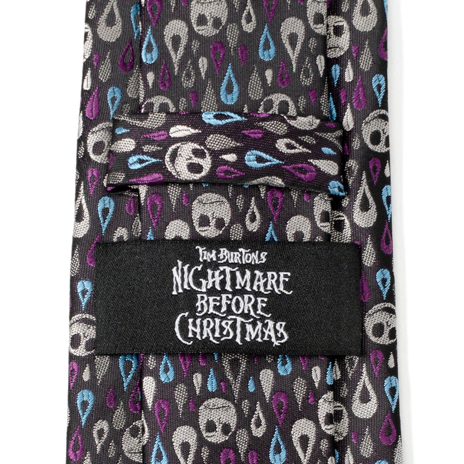The Disney The Nightmare Before Christmas Jack Skellington Patterned Men's Tie by Cufflinks.com features a black silk blend with white skulls and blue and purple teardrops—perfect for fans seeking a unique accessory.
