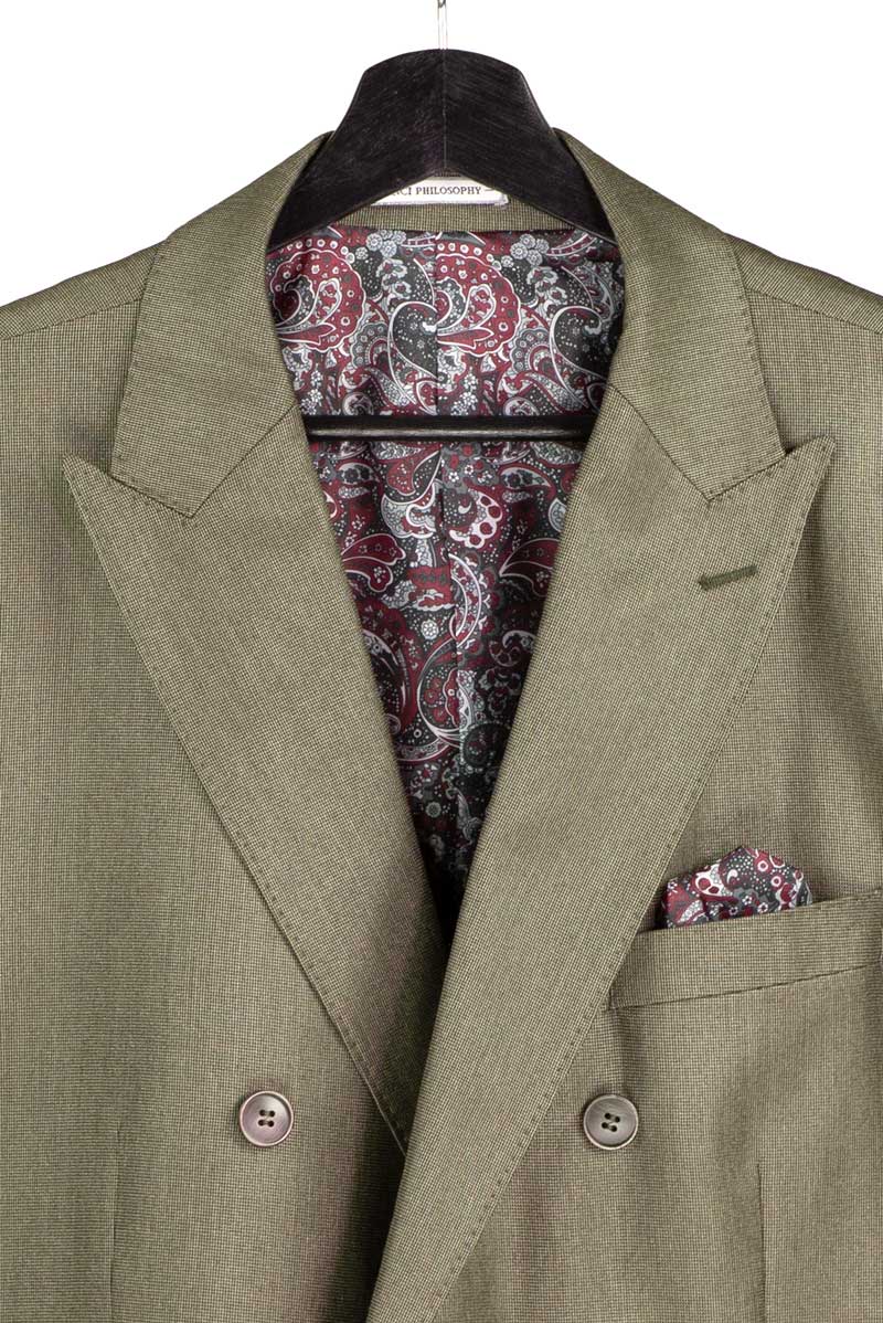 The Regular Fit Dusty Green Double Breasted 2 Piece Sharkskin Suit with Adjustable Waistband Pants DRK-5 by Vinci Suits is shown with a black shirt, floral green tie, pocket square, and lapel pin.