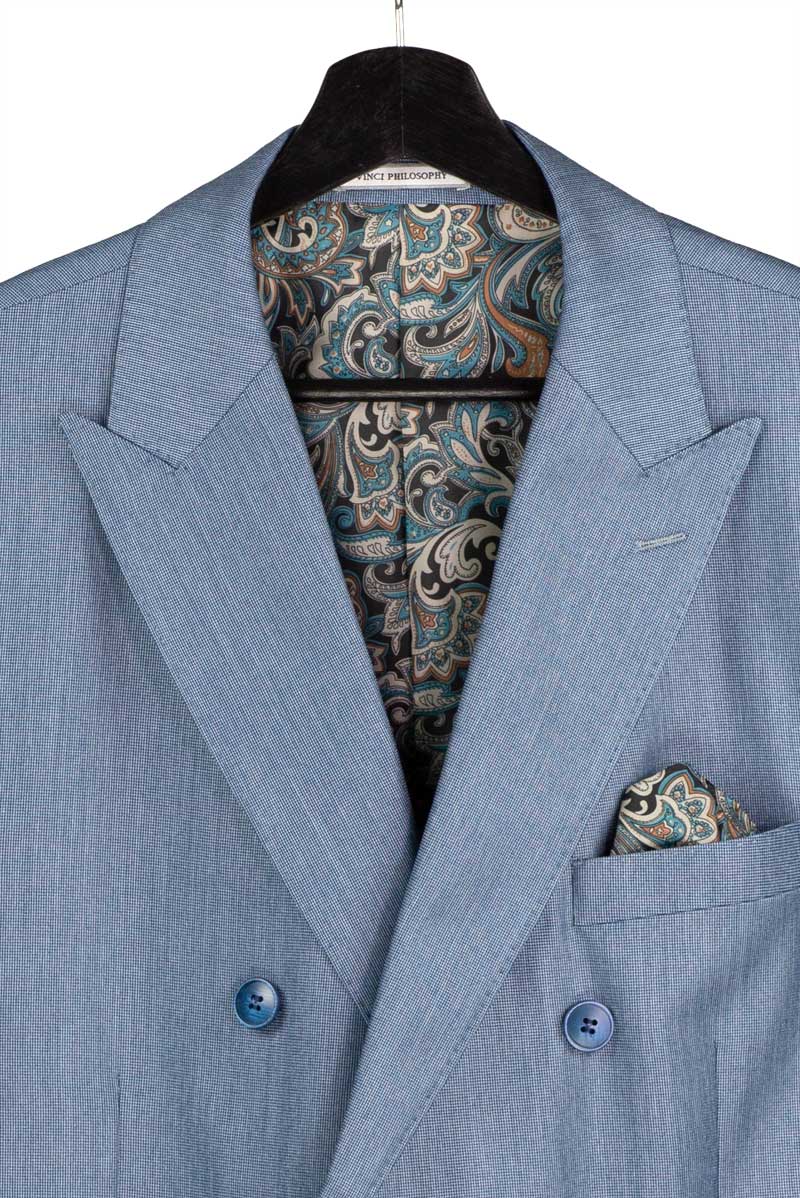 A mannequin showcases the Vinci Suits Regular Fit Smoke Blue Double Breasted 2 Piece Sharkskin Suit with Adjustable Waistband Pants DRK-5, paired with a white shirt and tie.