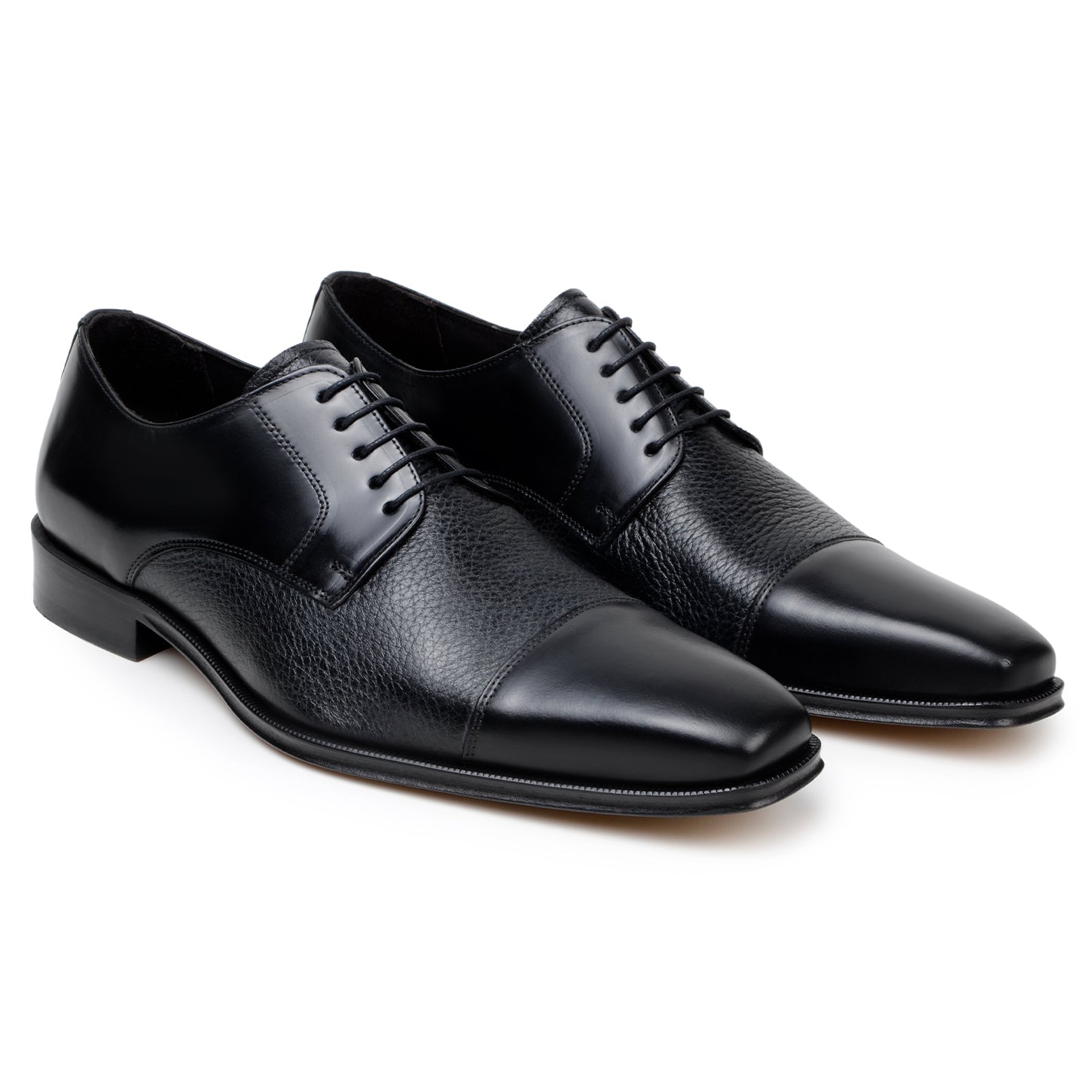 The BELVEDERE Alexander is a black men's dress shoe made of genuine Italian deerskin and calf, featuring a cap toe, lace-up closure, and low heel. Handcrafted in Brazil, shown in side profile on a white background.