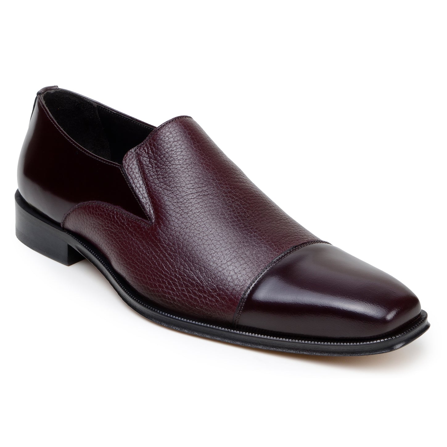 The BELVEDERE Andreo is a genuine Italian deerskin and calf burgundy dress shoe, featuring a slip-on design, low black heel, and mixed smooth-textured finishes—crafted for style and comfort.