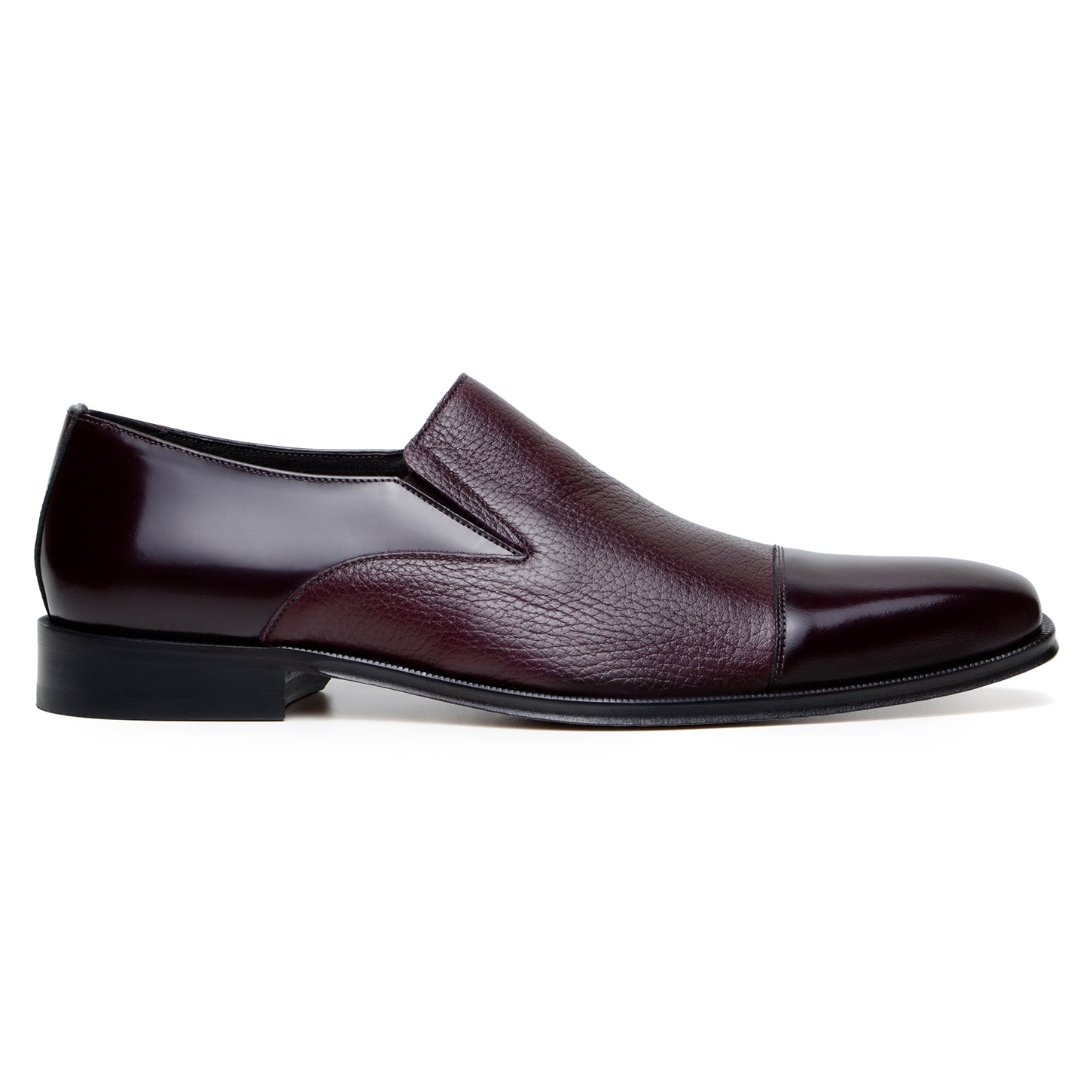 The BELVEDERE Andreo is a genuine Italian deerskin and calf burgundy dress shoe, featuring a slip-on design, low black heel, and mixed smooth-textured finishes—crafted for style and comfort.