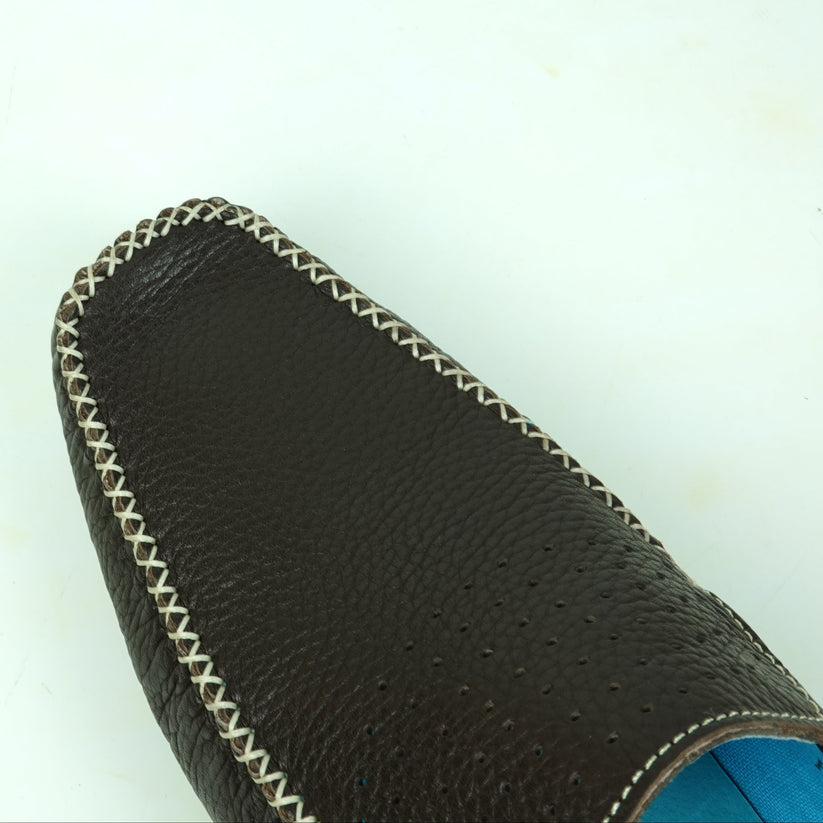 A single FI-4001 Brown Fiesso By Aurelio Garcia loafer by Fiesso is displayed from a side angle on a white background, featuring black slip-on leather with white stitching, blue inner lining, a brown sole, and a cushioned insole for added comfort.