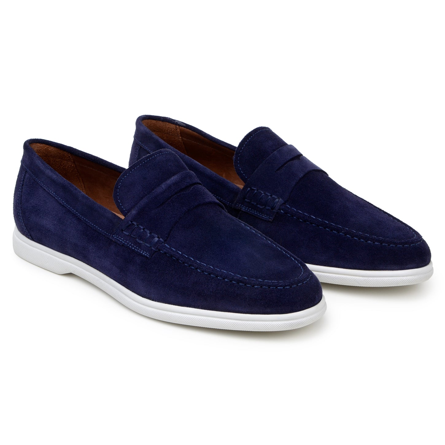 The BELVEDERE Niko is a men's penny loafer in navy Italian suede with hand-stitching and a white rubber sole, shown in side profile against a white background.