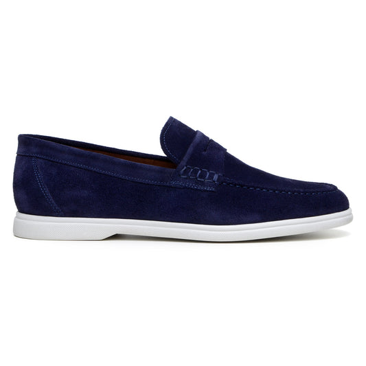 The BELVEDERE Niko is a men's penny loafer in navy Italian suede with hand-stitching and a white rubber sole, shown in side profile against a white background.