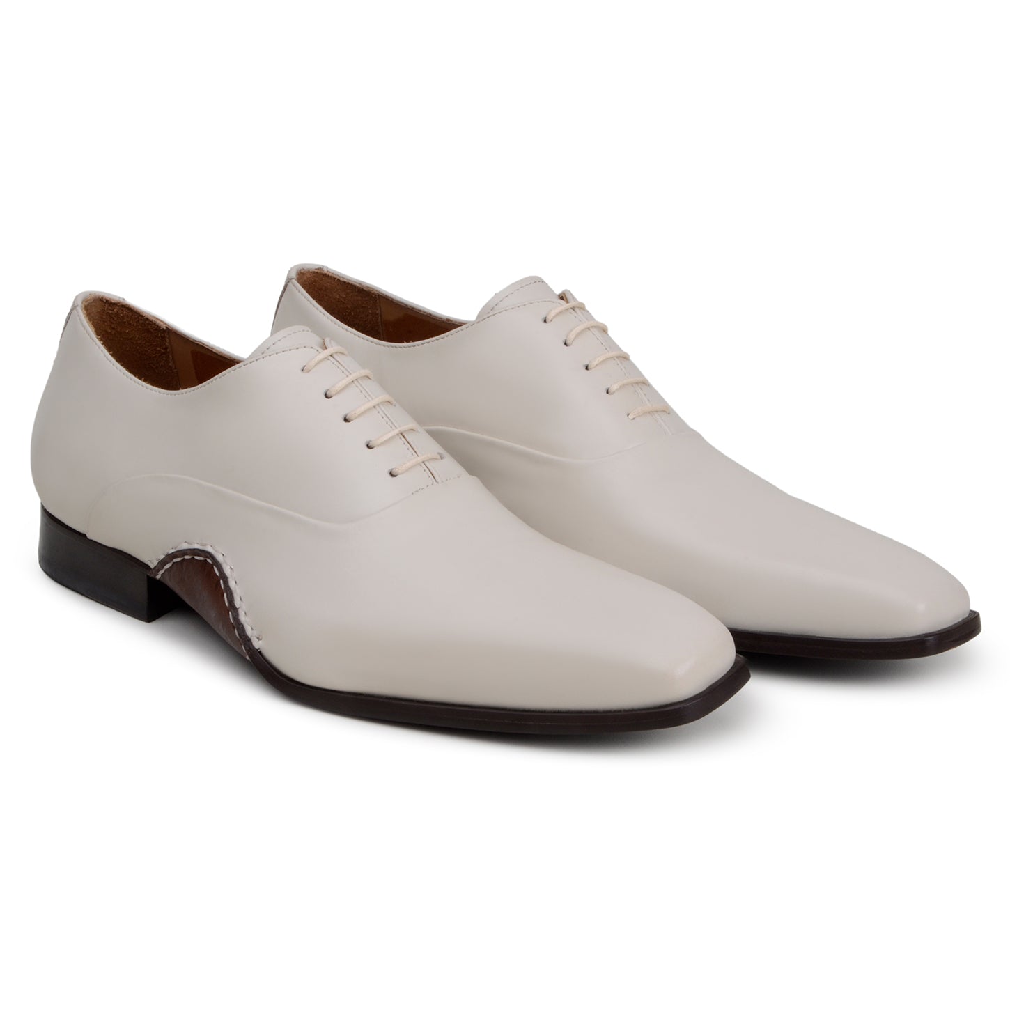 The BELVEDERE Belvedere - Bianca Italian Calf Dress Shoe in Light Bone is a cream-colored full leather oxford with a low heel, brown sole, white stitching, and closed lacing, shown in profile against a white background.