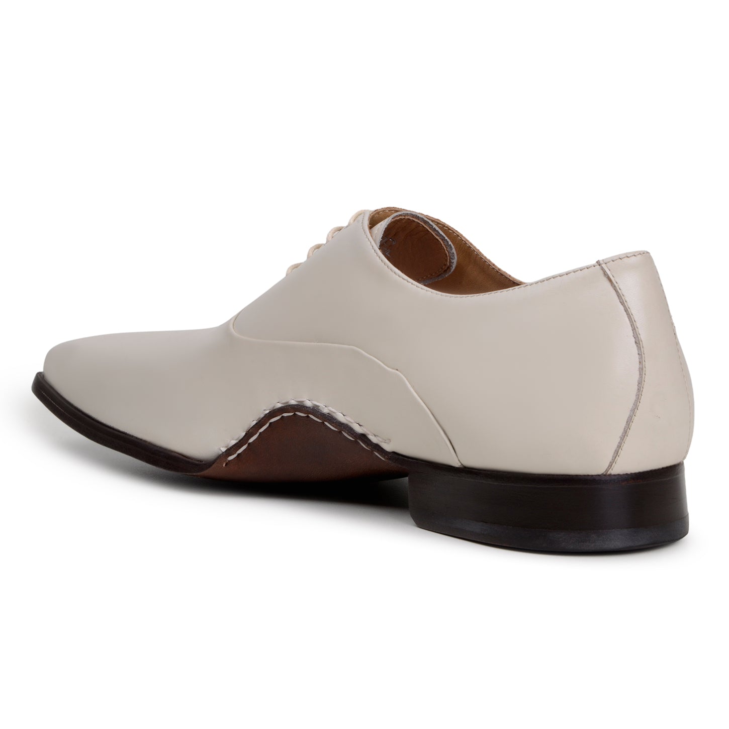 The BELVEDERE Belvedere - Bianca Italian Calf Dress Shoe in Light Bone is a cream-colored full leather oxford with a low heel, brown sole, white stitching, and closed lacing, shown in profile against a white background.