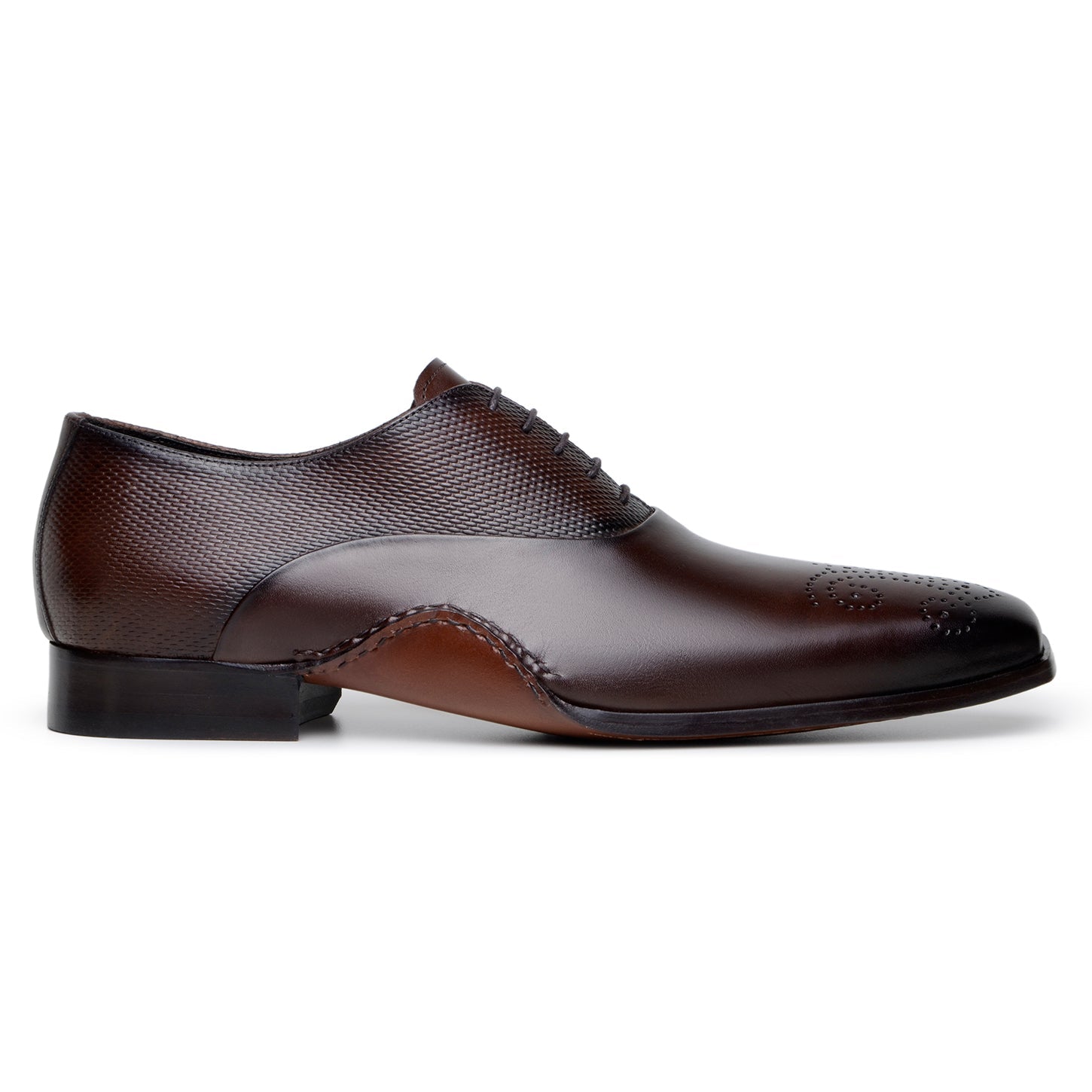 The BELVEDERE Saggio is an Ant. Tobacco Italian calf leather dress shoe with textured panels, toe perforations, a low heel, and handcrafted in Brazil with fine Opanka construction.