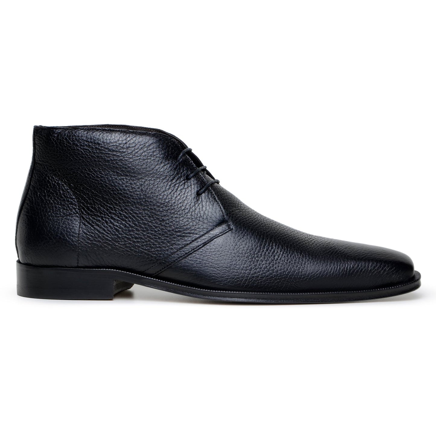 The BELVEDERE Axel is a black genuine Italian deerskin boot with a textured finish, minimal stitching, and a low heel, handcrafted in Brazil and shown in profile against a white background.