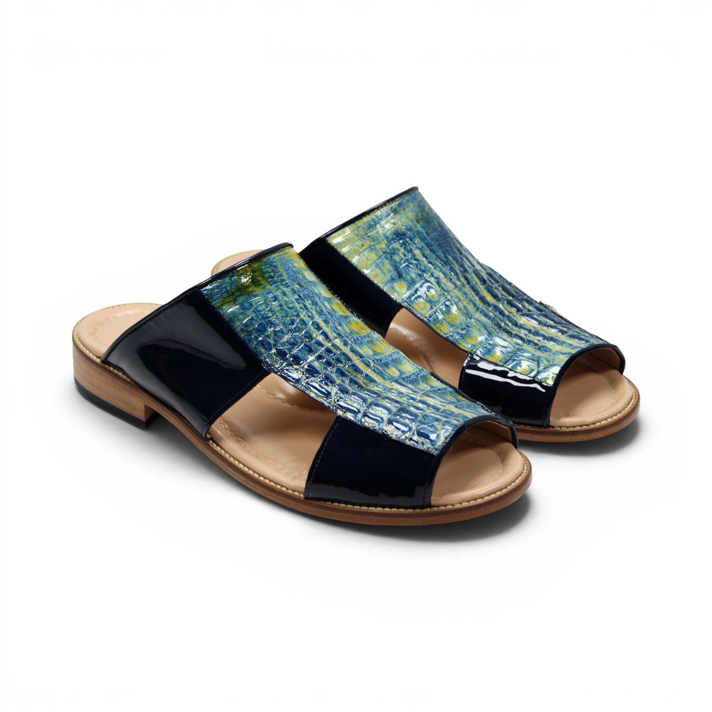 A side view of the Fennix Diego Blue sandal by Fennix of Italy, featuring a wooden sole, black patent leather sides, and a textured blue upper with intricate cut-out detailing—exemplifying the exotic luxury typical of Italian craftsmanship.