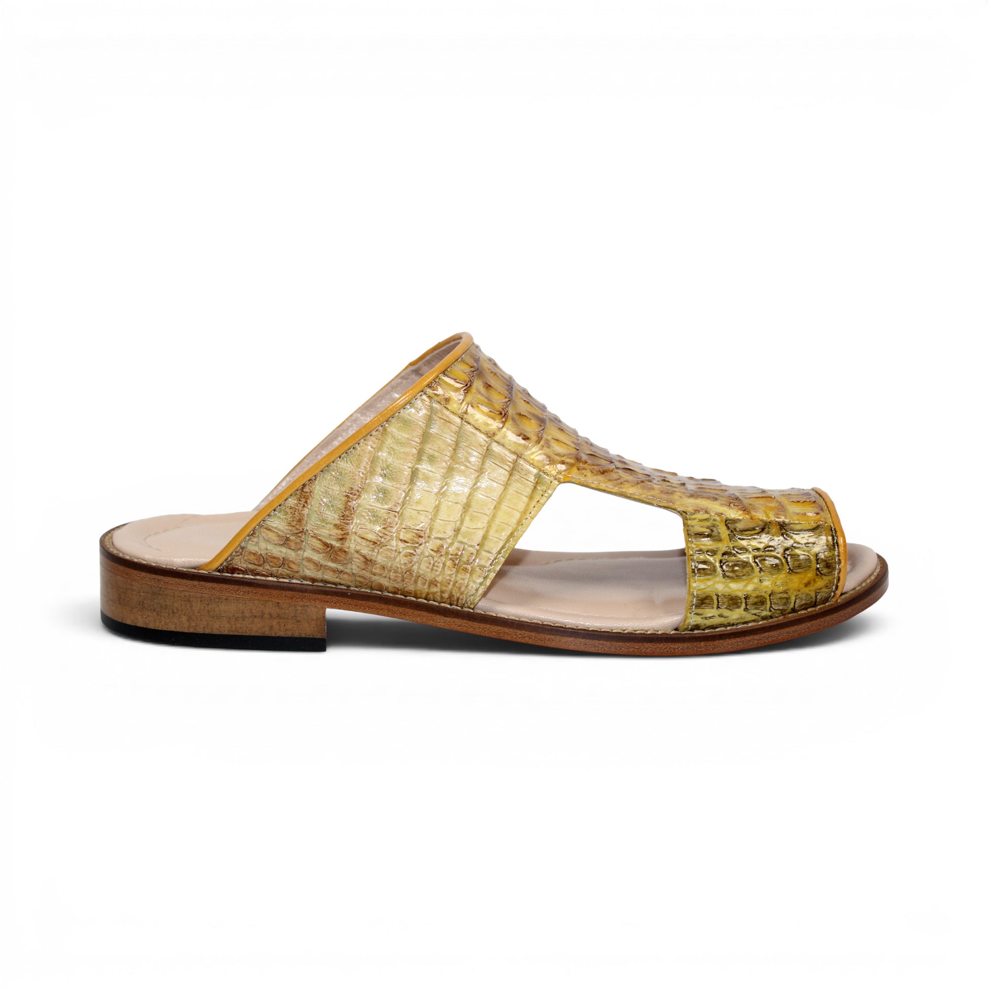 The Fennix Diego Yellow slide sandal by Fennix of Italy features yellow crocodile-embossed leather, an open toe, a wide strap, and a flat wooden sole—an eye-catching piece of exotic footwear inspired by Italian-made luxury shoes, shown from the side against a white background.