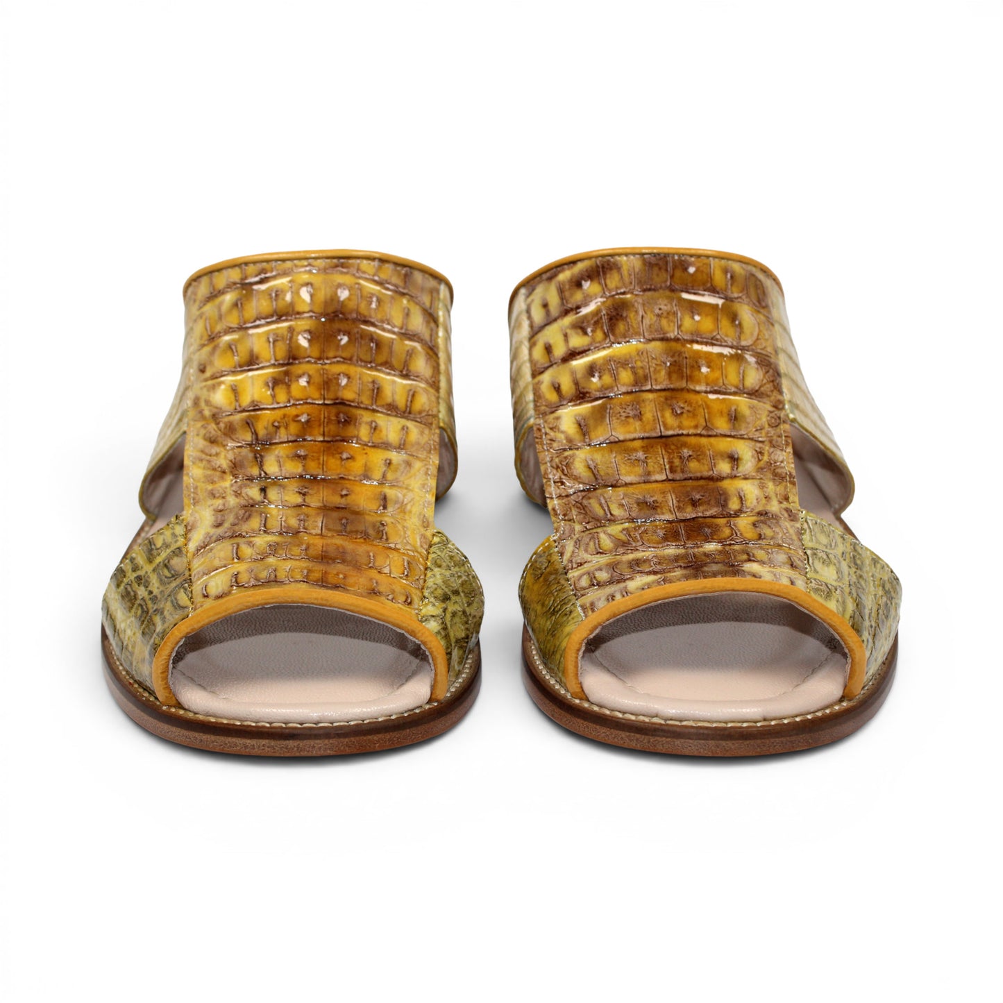 The Fennix Diego Yellow slide sandal by Fennix of Italy features yellow crocodile-embossed leather, an open toe, a wide strap, and a flat wooden sole—an eye-catching piece of exotic footwear inspired by Italian-made luxury shoes, shown from the side against a white background.
