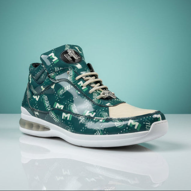 Displayed on a wooden surface in a clothing store, the Mauri 8900 Green / Tan Shoes (FINAL SALE, SIZE 9 ONLY) feature green baby crocodile leather with distinctive white “M” patterns, tan laces, transparent sections, and a white sole. Showcasing patent leather accents and expertly custom made in Italy by Mauri, this unique sneaker seamlessly combines premium style with exceptional craftsmanship.
