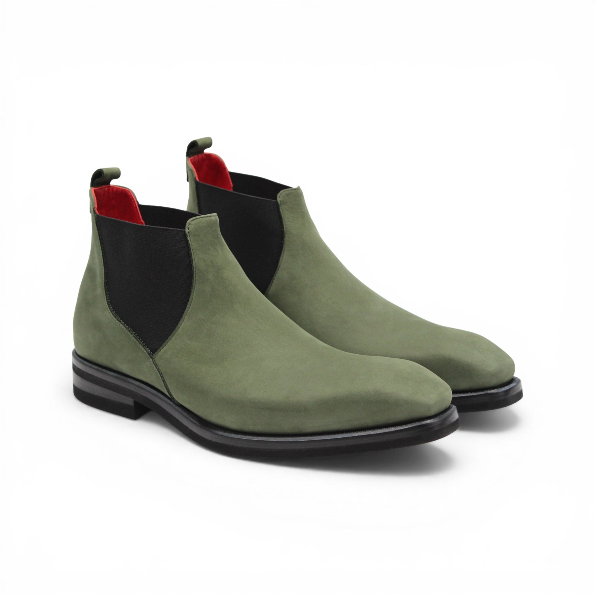 The Emilio Franco EF311 Olive is a green leather Chelsea boot crafted from genuine Italian nabuk, featuring black elastic side panels, a black sole, and a red pull tab at the heel. Presented in profile on a white background, this shoe by Emilio Franco effortlessly blends casual elegance with timeless style.