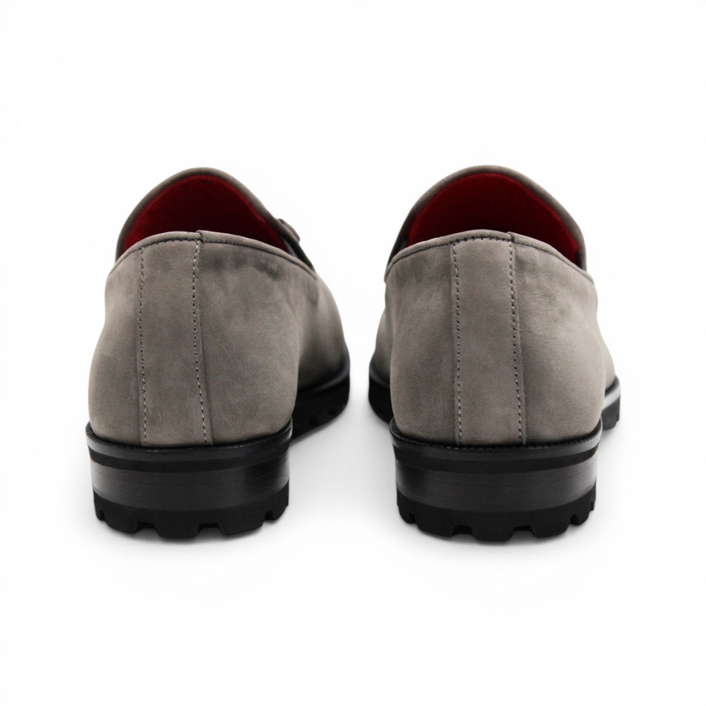 The Emilio Franco EF363 Gray loafer is expertly crafted from Genuine Nabuk in a sophisticated gray hue. It features a black rubber sole, silver buckle accent, and striking red interior lining. Displayed in a side profile against a white background, this classic Italian shoe by Emilio Franco embodies refined elegance.