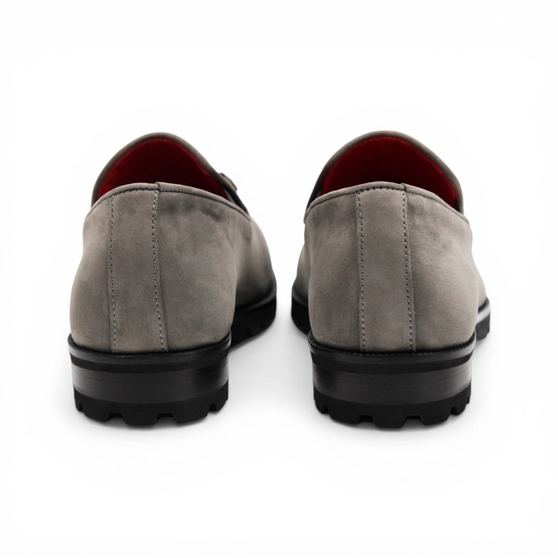 The Emilio Franco EF363 Gray loafer is expertly crafted from Genuine Nabuk in a sophisticated gray hue. It features a black rubber sole, silver buckle accent, and striking red interior lining. Displayed in a side profile against a white background, this classic Italian shoe by Emilio Franco embodies refined elegance.