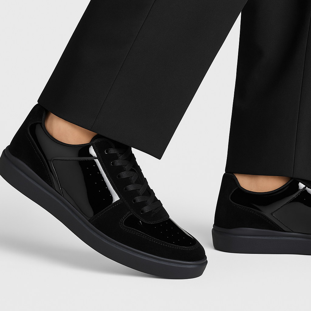 The BELVEDERE Edmound is a black low-top sneaker in patent leather and velvet, featuring glossy side panels, matte suede accents, black laces, and a rubber sole. Available in size 9.5 and 11.5 only. IN STORE FINAL SALE.