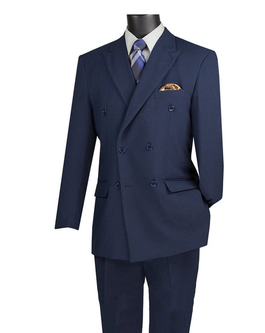 On a mannequin, Vinci Suits' Regular Fit Double Breasted 2 Piece Suit in Navy F-DC900, featuring a crisp white shirt, striped tie, and pocket square, epitomizes timeless elegance. The suit includes wrinkle-resistant pants with a flexible elastic waistband for all-day sharpness.