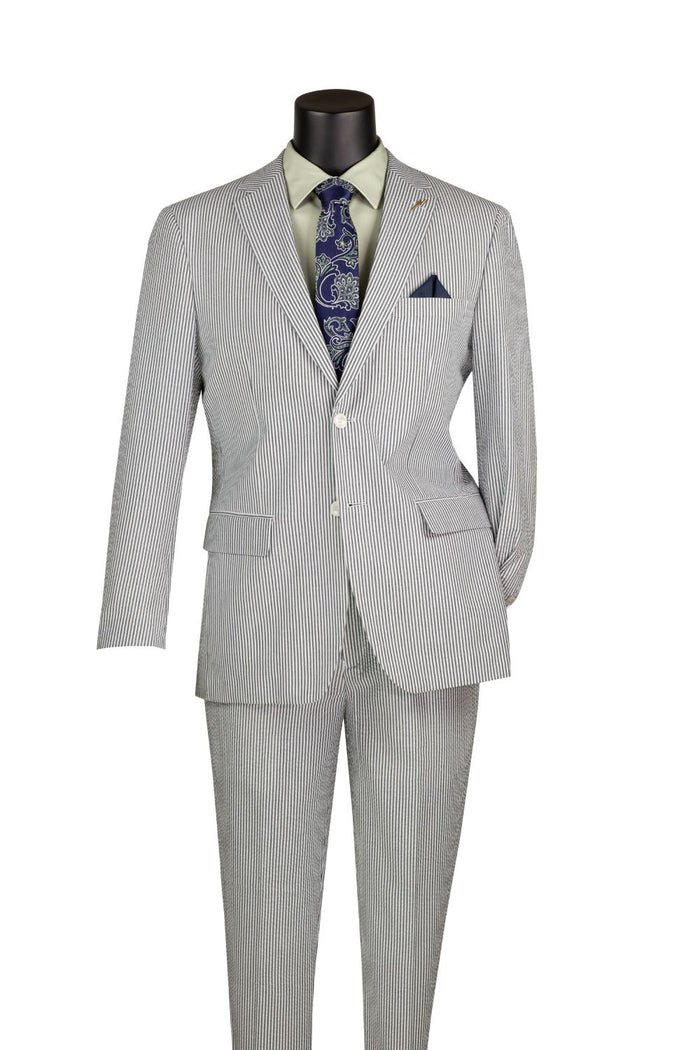 A mannequin showcases the Modern Fit Green Summer 2 Piece 2 Button Suit Striped Seersucker F-MSS1 by Vinci Suits with a green shirt, blue tie, and navy pocket square.