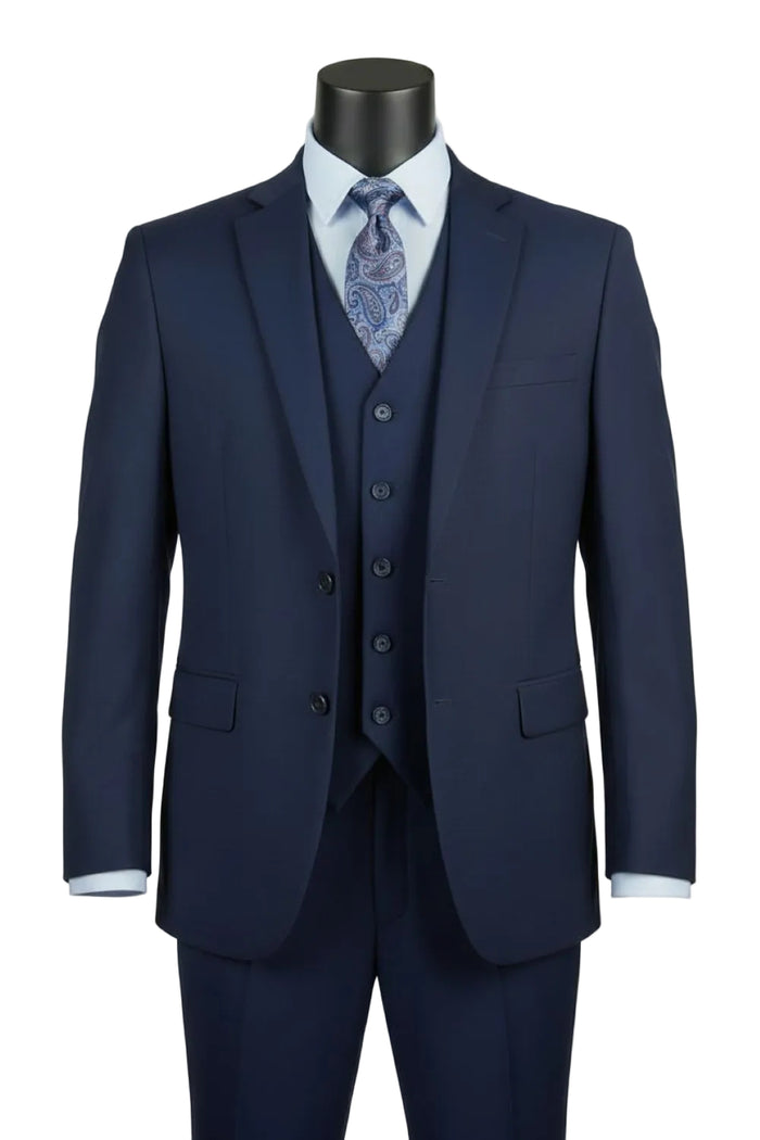 The Vinci Suits Regular Fit Navy 3 Piece Suit 2 Button with Adjustable Waistband Pants F-V2TR is shown on a mannequin with a light blue shirt and paisley tie.