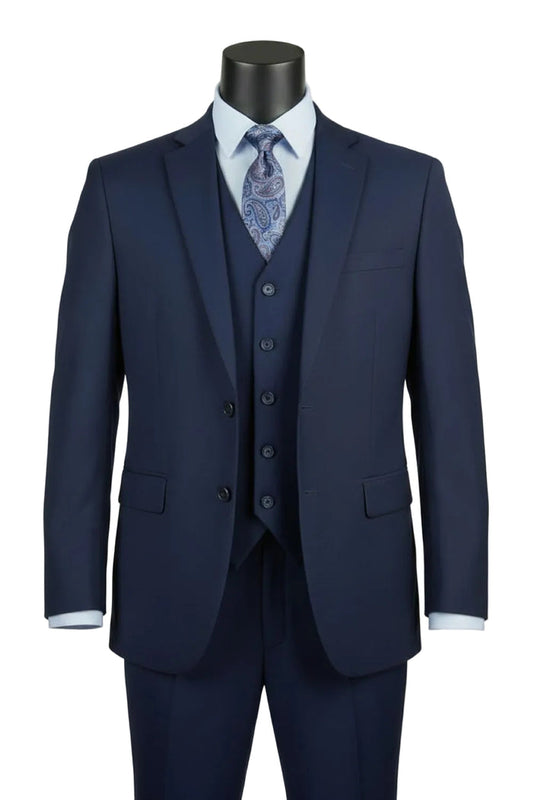 The Vinci Suits Regular Fit Navy 3 Piece Suit 2 Button with Adjustable Waistband Pants F-V2TR is shown on a mannequin with a light blue shirt and paisley tie.
