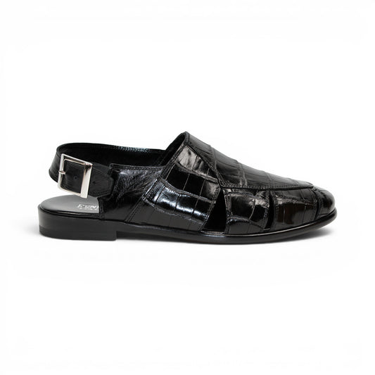Introducing the Fennix F131 Black sandal by Fennix of Italy—a black leather design featuring a closed toe, open heel, silver buckle strap, and a flat sole, elegantly displayed on a white background. Crafted for those who value luxury footwear, this sandal offers refined style and comfort with every step.