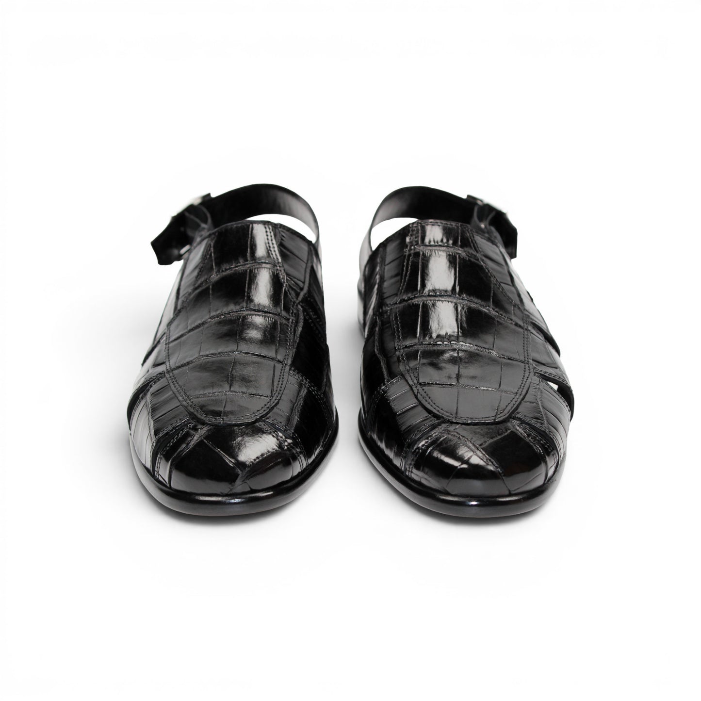 Introducing the Fennix F131 Black sandal by Fennix of Italy—a black leather design featuring a closed toe, open heel, silver buckle strap, and a flat sole, elegantly displayed on a white background. Crafted for those who value luxury footwear, this sandal offers refined style and comfort with every step.