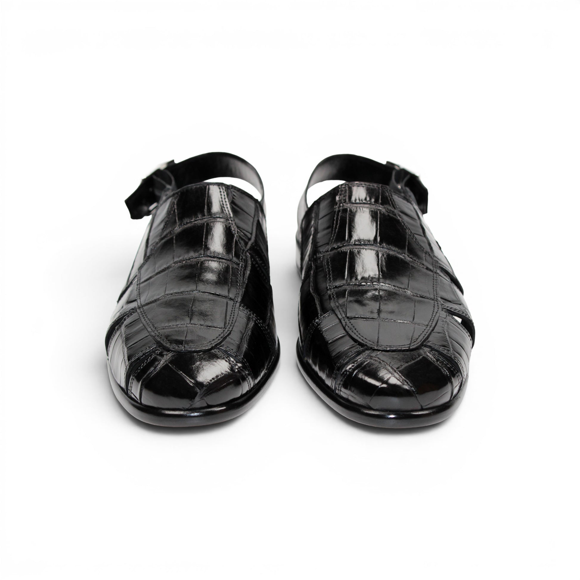 Introducing the Fennix F131 Black sandal by Fennix of Italy—a black leather design featuring a closed toe, open heel, silver buckle strap, and a flat sole, elegantly displayed on a white background. Crafted for those who value luxury footwear, this sandal offers refined style and comfort with every step.