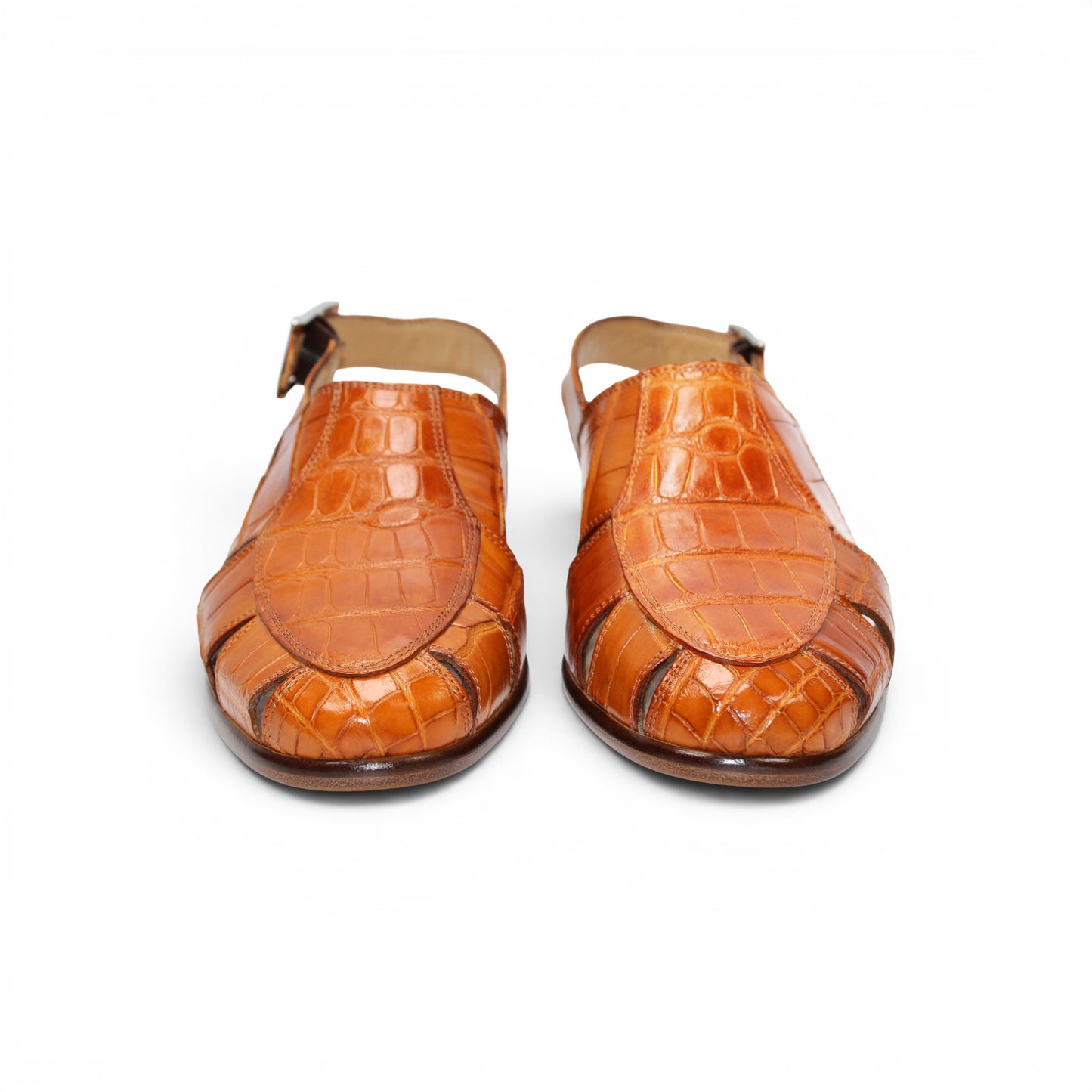 The Fennix F131 Cognac sandal by Fennix of Italy is an open-toe design crafted from genuine alligator leather in a rich brown hue, featuring elegant cut-outs, a slingback strap with side buckle, and a low flat heel—perfect for those who appreciate true luxury footwear. Displayed on a white background.