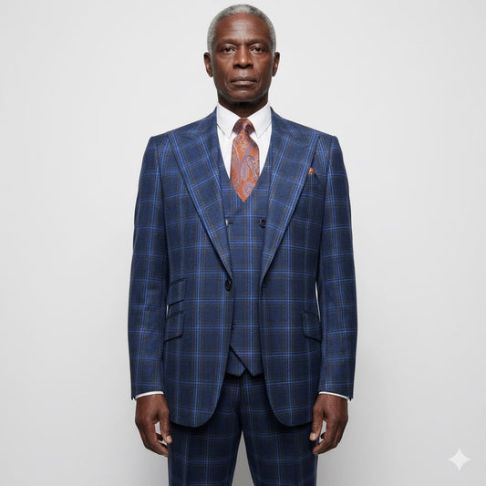 The mannequin displays a striking Tiglio Rosso Orvietto Blue/Rust Windowpane suit (sizes 50R and 52R), made from 100% wool, with a matching waistcoat and an orange tie beautifully contrasting the dark industrial background.