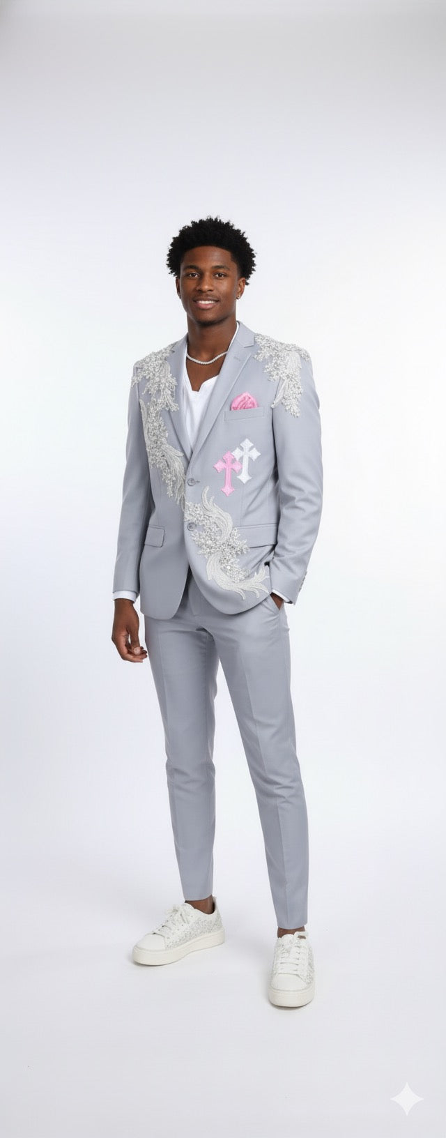 A man models the Unique Design Menswear Custom Prom Suit in white-grey with silver rhinestones, paired with a white shirt, sneakers, and a pink pocket square—ideal for anyone seeking standout custom looks.