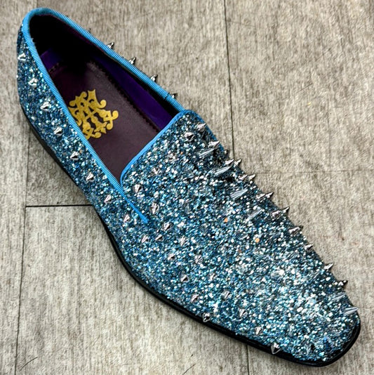 The Exclusive Formal Dress Shoe Blue 6788 from UNIQUE DESIGN MENSWEAR, adorned with sequins and metallic spikes, rests on a gray surface and is expertly crafted in Italy from exquisite genuine leather.