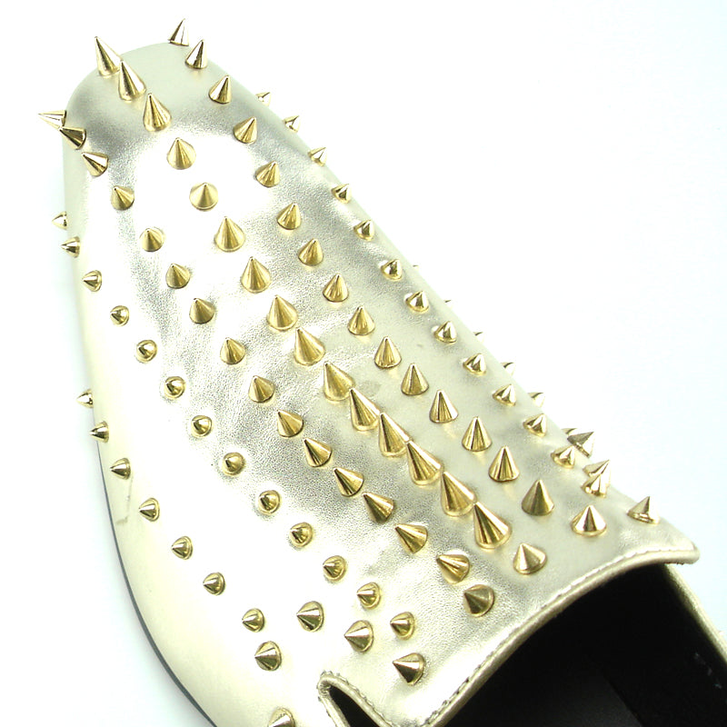 Step into style with the FI-7107 Gold Fiesso by Aurelio Garcia—a metallic gold leather slip-on dress shoe from Fiesso, featuring numerous gold spikes on the upper and heel. Photographed against a white background, this striking pair makes an exceptional choice for men’s fashion shoes.