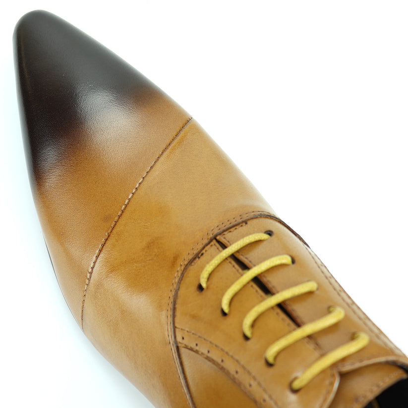 FI-7281 Tan Lace Up Encore by Fiesso is a brown leather dress shoe featuring a pointed toe, black gradient tip, yellow laces, and a low heel, artfully photographed on a white background. This remarkable design from Fiesso exemplifies the impeccable quality of handcrafted leather shoes—making it an essential addition to any men’s fashion shoe collection.