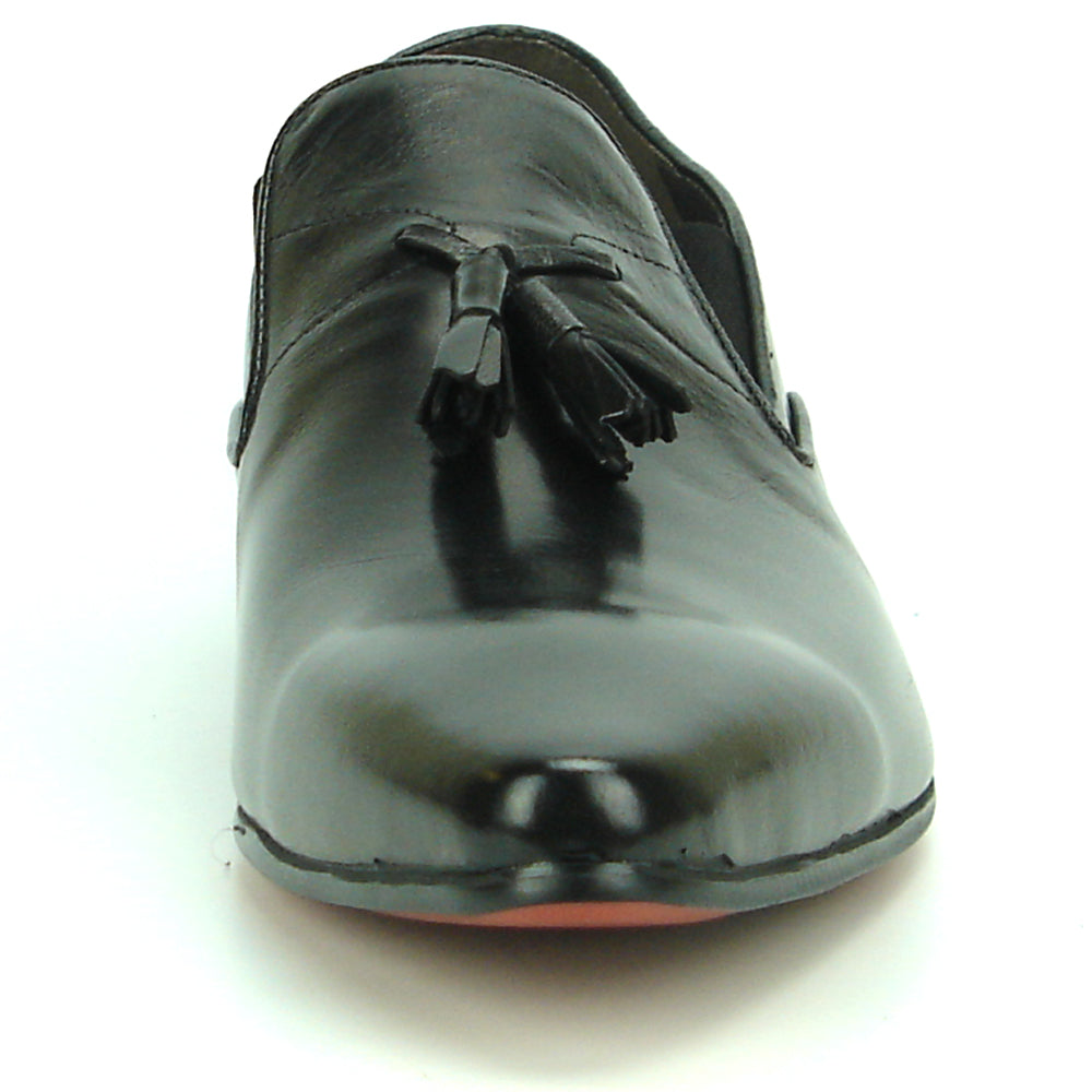The FI-7287 Black Leather Slip On With Tassel by Fiesso features a pointed toe, low heel, and elegant tassels, inspired by men’s fashion. Displayed on a white background, this loafer adds sophistication to your style.