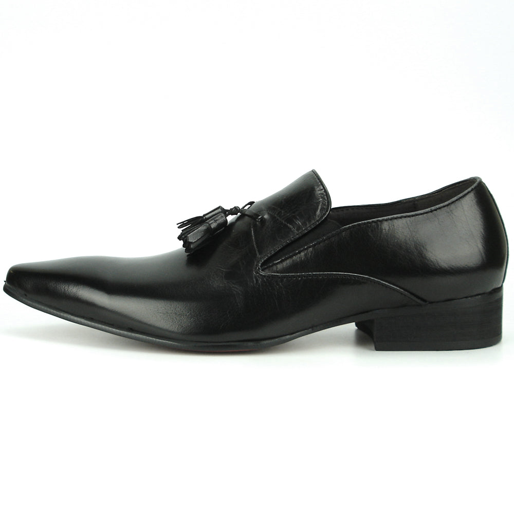 The FI-7287 Black Leather Slip On With Tassel by Fiesso features a pointed toe, low heel, and elegant tassels, inspired by men’s fashion. Displayed on a white background, this loafer adds sophistication to your style.