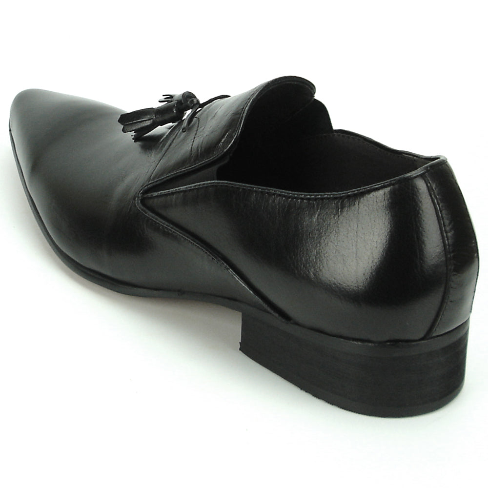 The FI-7287 Black Leather Slip On With Tassel by Fiesso features a pointed toe, low heel, and elegant tassels, inspired by men’s fashion. Displayed on a white background, this loafer adds sophistication to your style.