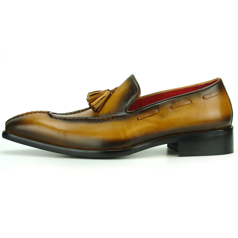 The FI-8701 Tan Encore by Fiesso is a handcrafted men’s leather loafer in brown, with tassels, darker shading on the toe and heel, and a red interior lining.