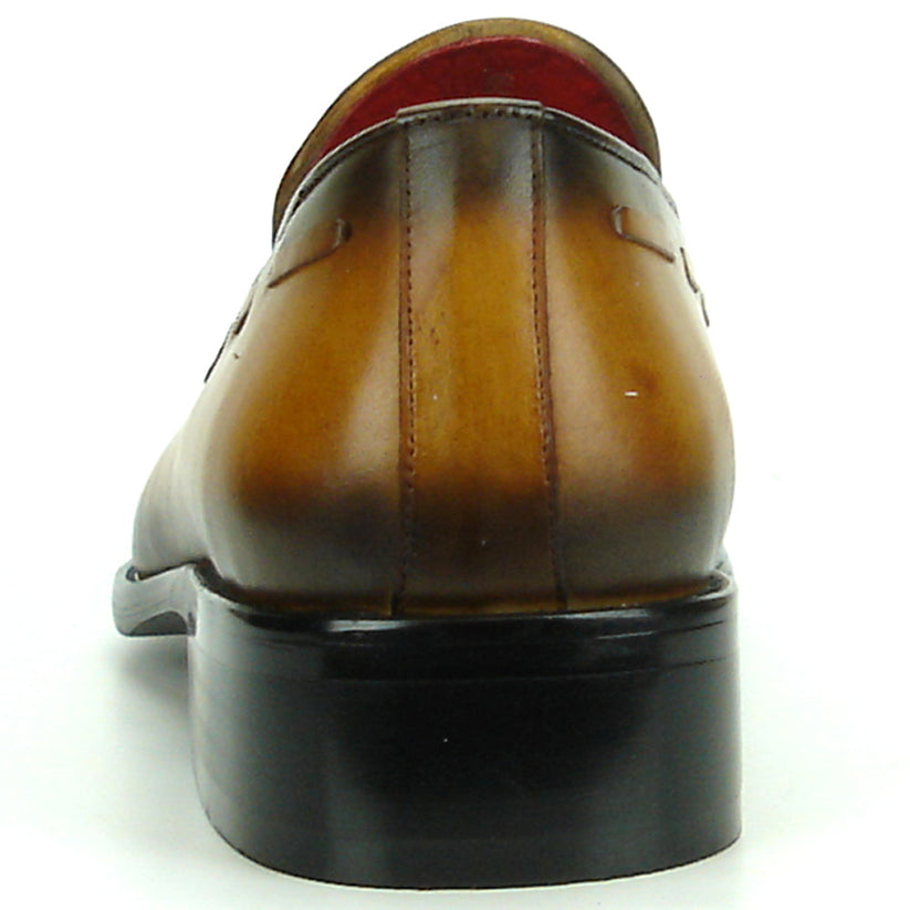 The FI-8701 Tan Encore by Fiesso is a handcrafted men’s leather loafer in brown, with tassels, darker shading on the toe and heel, and a red interior lining.
