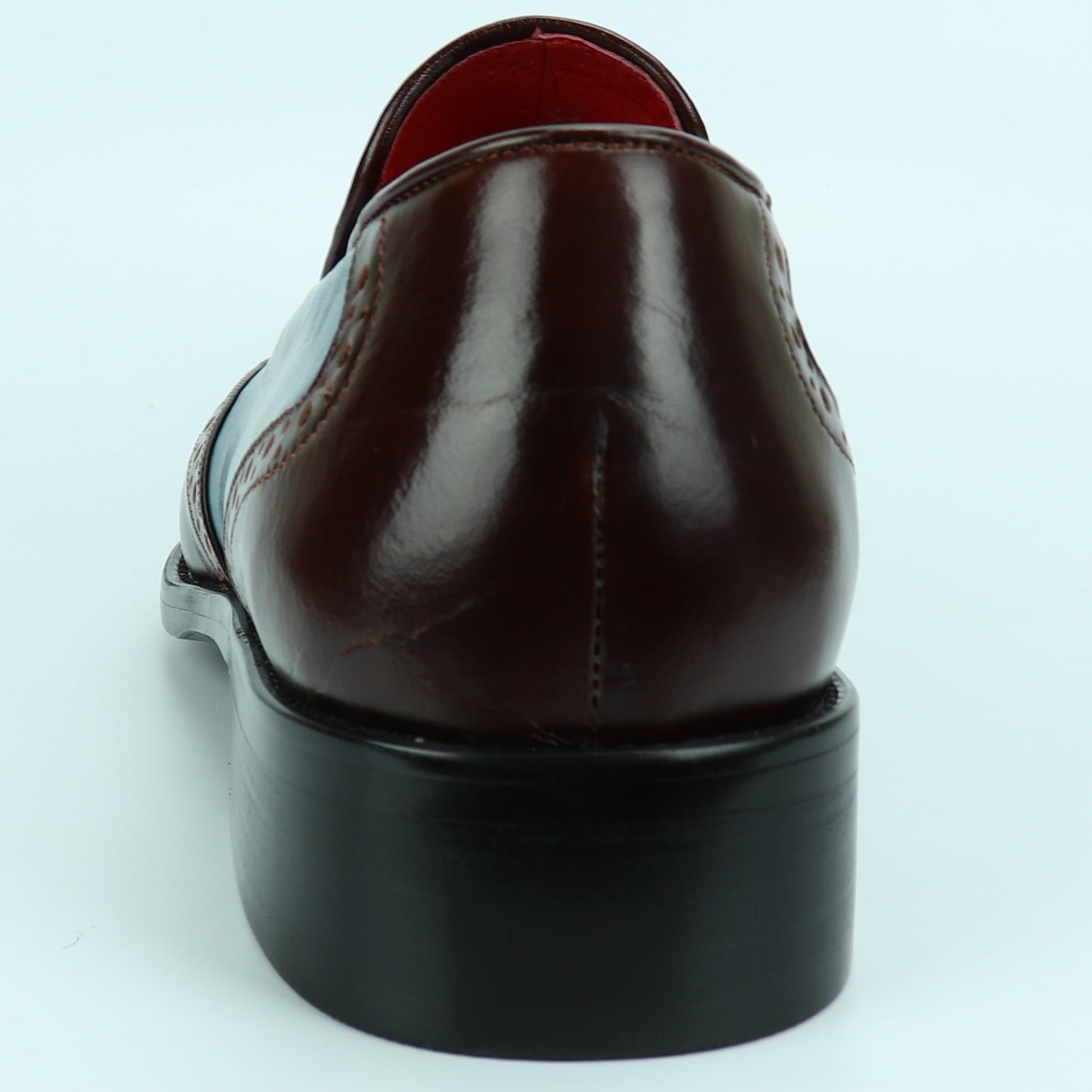 The FI-8705 Burgundy Blue Wing Tip With Tassel Encore by Fiesso features premium leather in burgundy and blue, classic brogue perforations, front tassels, and a black sole—perfect for elevating any outfit with Fiesso’s signature style.