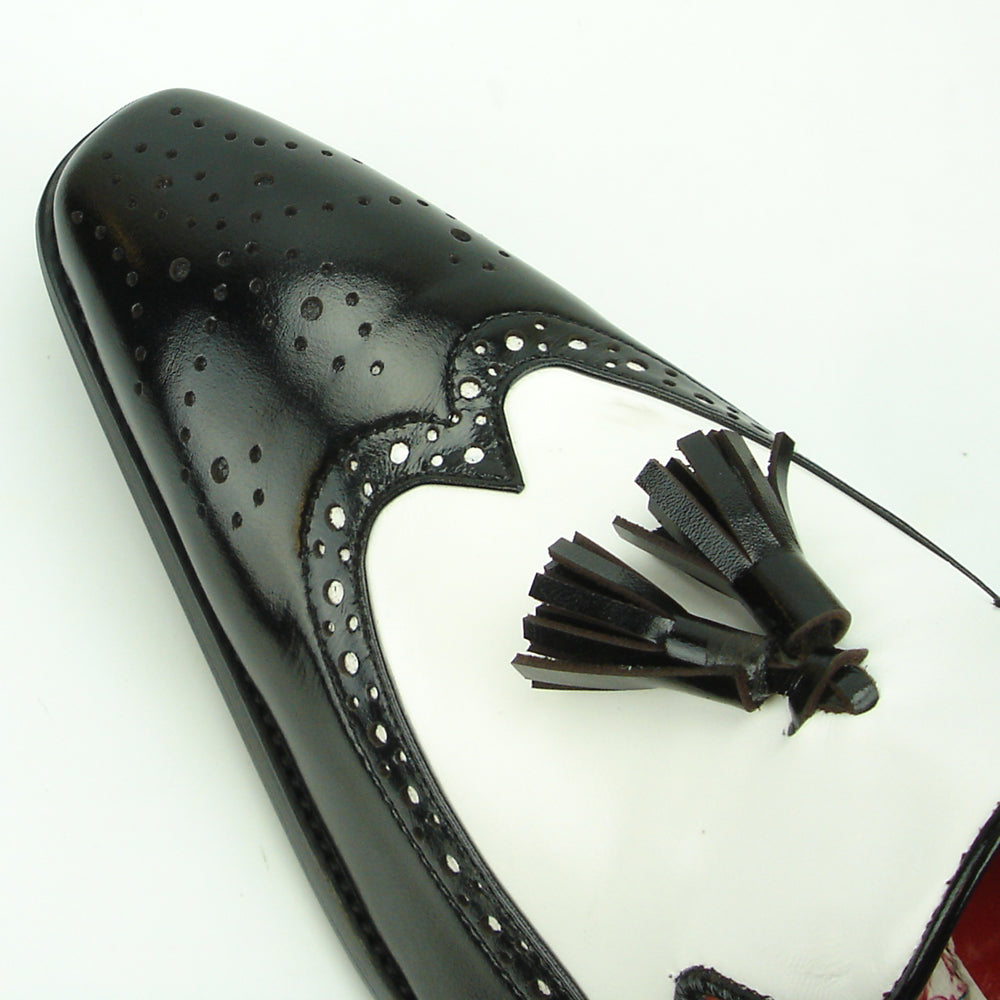 The FI-8705 Black White Wing Tip With Tassel Encore by Fiesso features hand-crafted leather, front tassels, perforated detailing, and a low heel—a true statement in men's fashion.