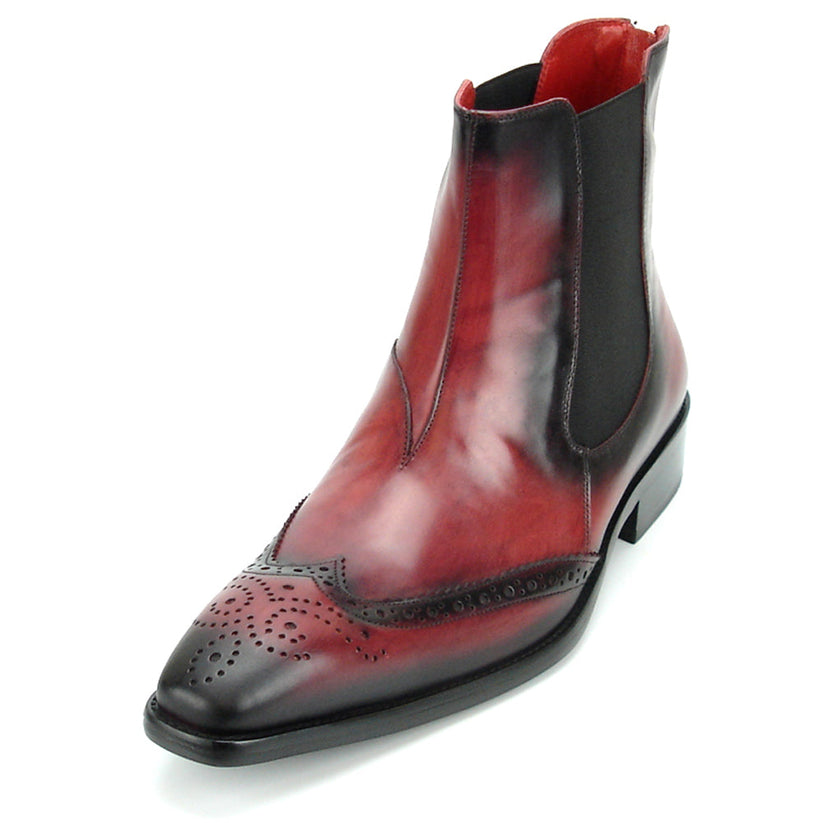 A handcrafted burgundy leather Chelsea boot with black wingtip brogue detailing, elastic side panels, and a low heel—shown on a white background—FI-8708 Wing Tip Boot Encore by Fiesso exemplifies men’s fashion boots from the brand.