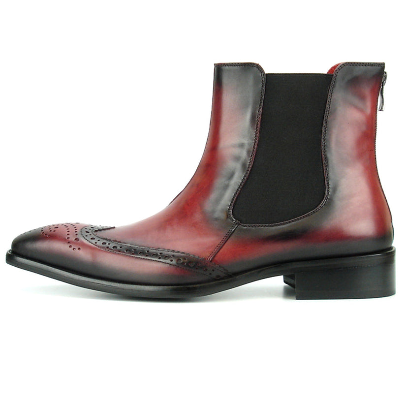 A handcrafted burgundy leather Chelsea boot with black wingtip brogue detailing, elastic side panels, and a low heel—shown on a white background—FI-8708 Wing Tip Boot Encore by Fiesso exemplifies men’s fashion boots from the brand.