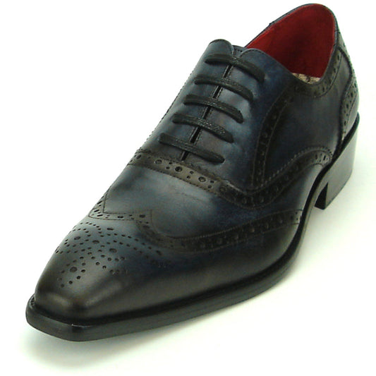The FI-8710 Black Wing Tip Encore by Fiesso, a men’s fashion shoe in black and navy blue crafted from leather with decorative perforations, black laces, and a low heel, is displayed on a white background.
