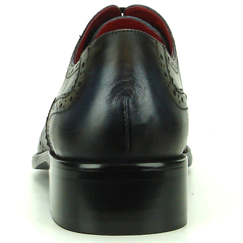 The FI-8710 Black Wing Tip Encore by Fiesso, a men’s fashion shoe in black and navy blue crafted from leather with decorative perforations, black laces, and a low heel, is displayed on a white background.