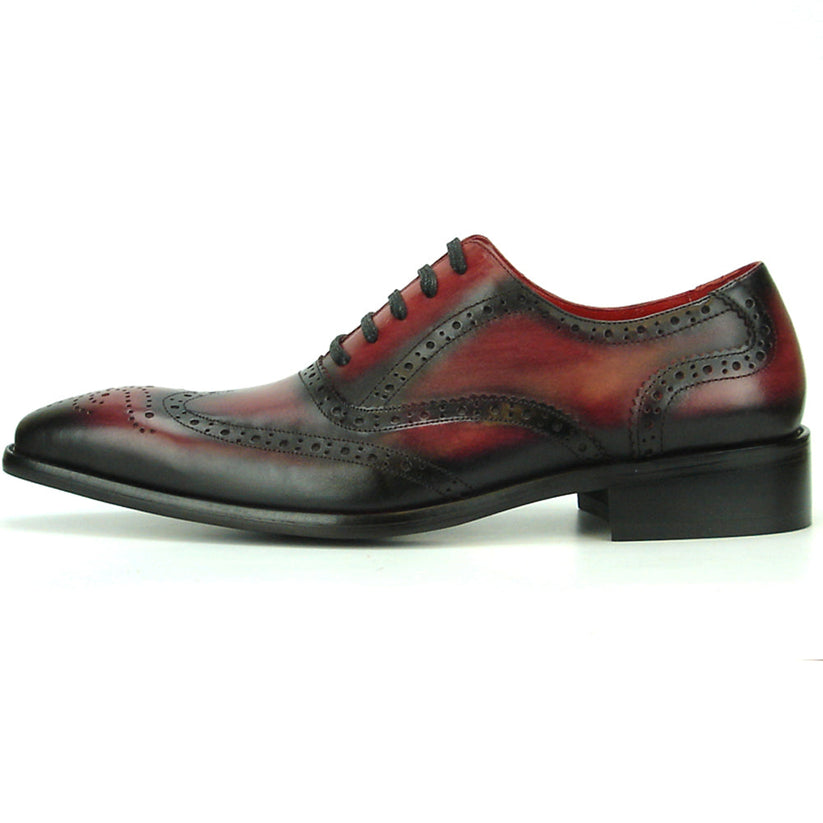 Introducing the FI-8710 Burgundy Wing Tip Encore by Fiesso—a single oxford dress shoe crafted from burgundy and black handcrafted leather, featuring classic brogue detailing, black laces, and a stylish low heel. This exceptional shoe from Fiesso is a standout choice for those seeking distinctive men’s fashion footwear.