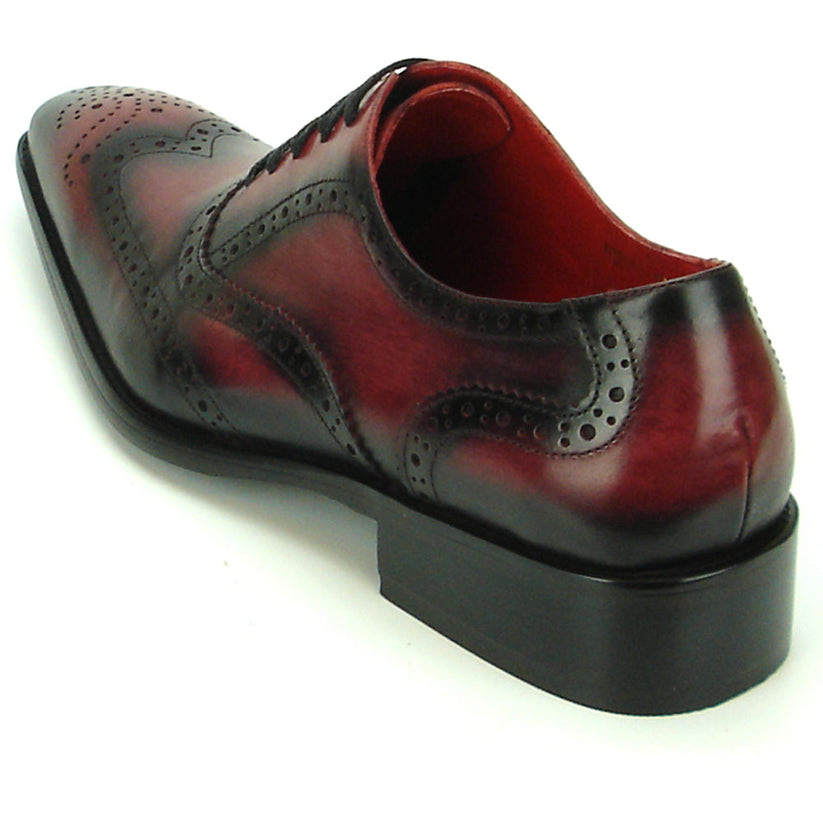 Introducing the FI-8710 Burgundy Wing Tip Encore by Fiesso—a single oxford dress shoe crafted from burgundy and black handcrafted leather, featuring classic brogue detailing, black laces, and a stylish low heel. This exceptional shoe from Fiesso is a standout choice for those seeking distinctive men’s fashion footwear.