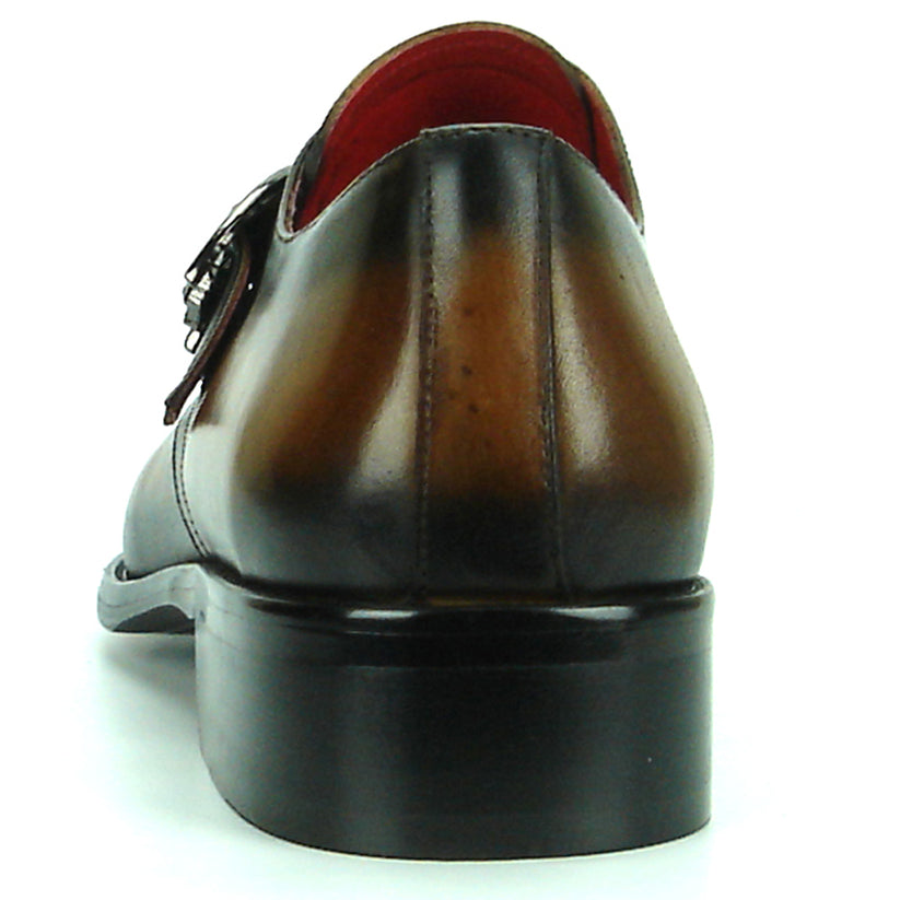 FI-8712 Coffee Encore by Fiesso—this handcrafted men’s dress shoe features rich brown leather, a pointed toe, black accent panels, a sleek side buckle, and a low heel. Displayed against a white background, it exemplifies the distinguished elegance of the Fiesso brand.